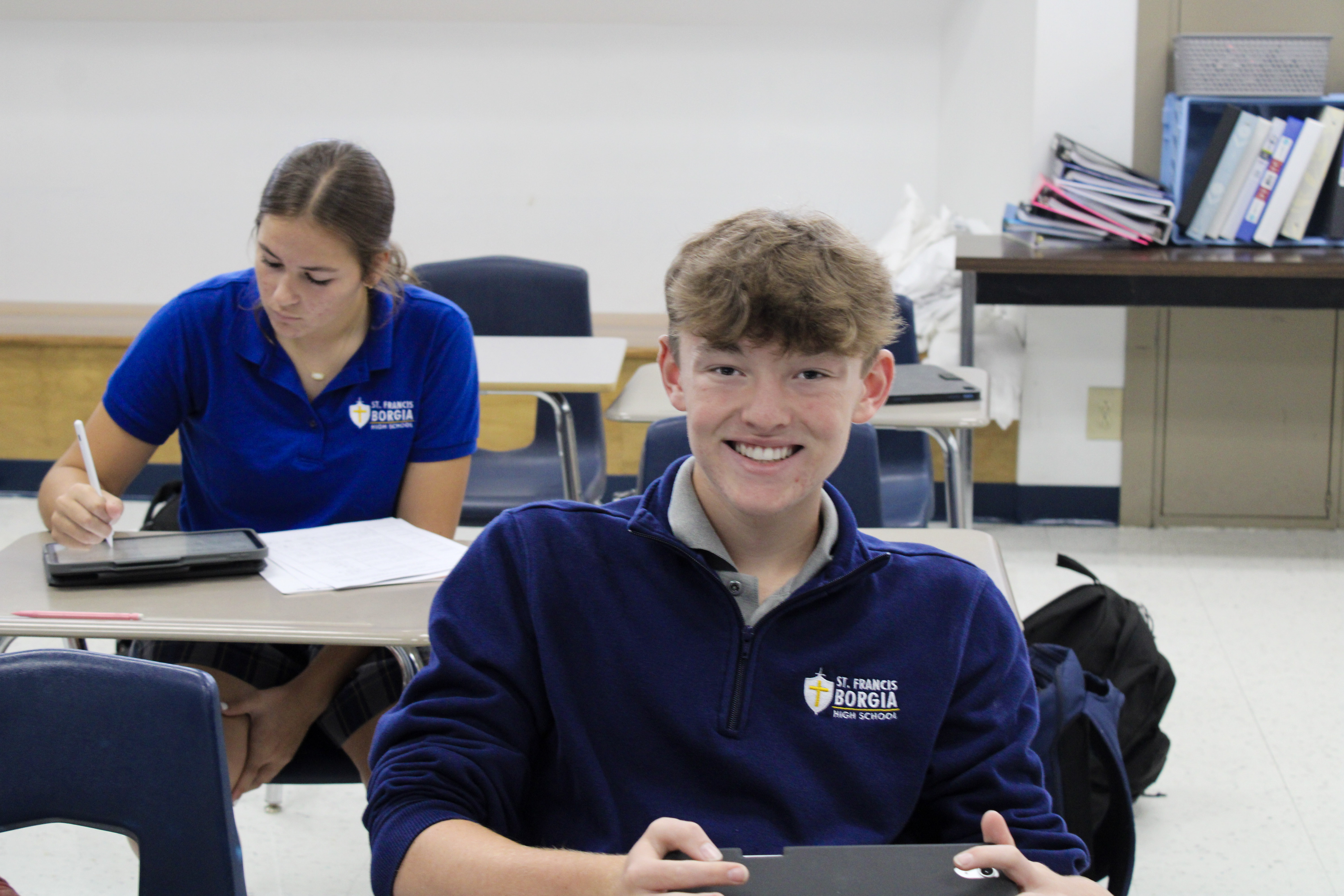 High school student seated, smiling