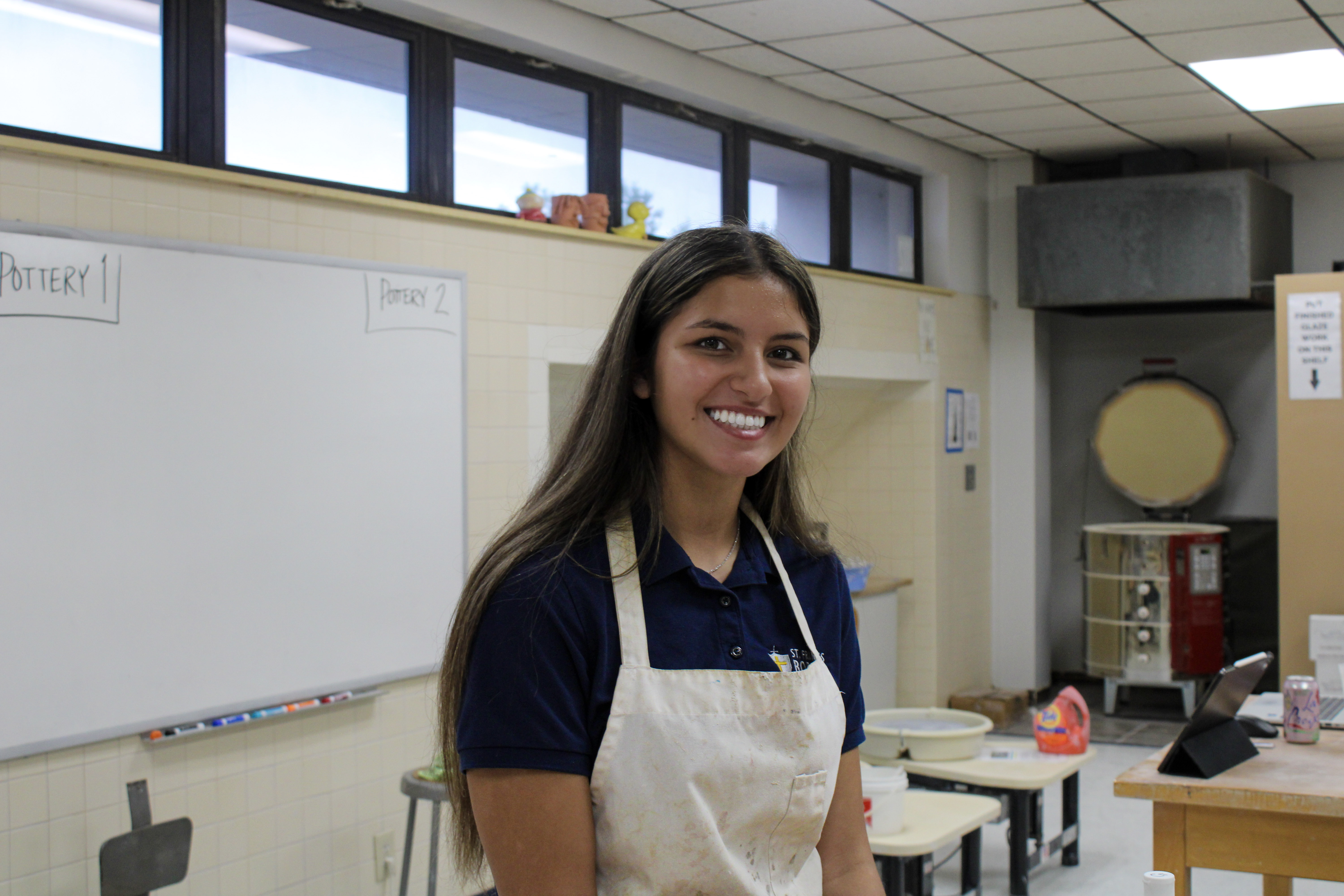 High school student wearing a lab apron