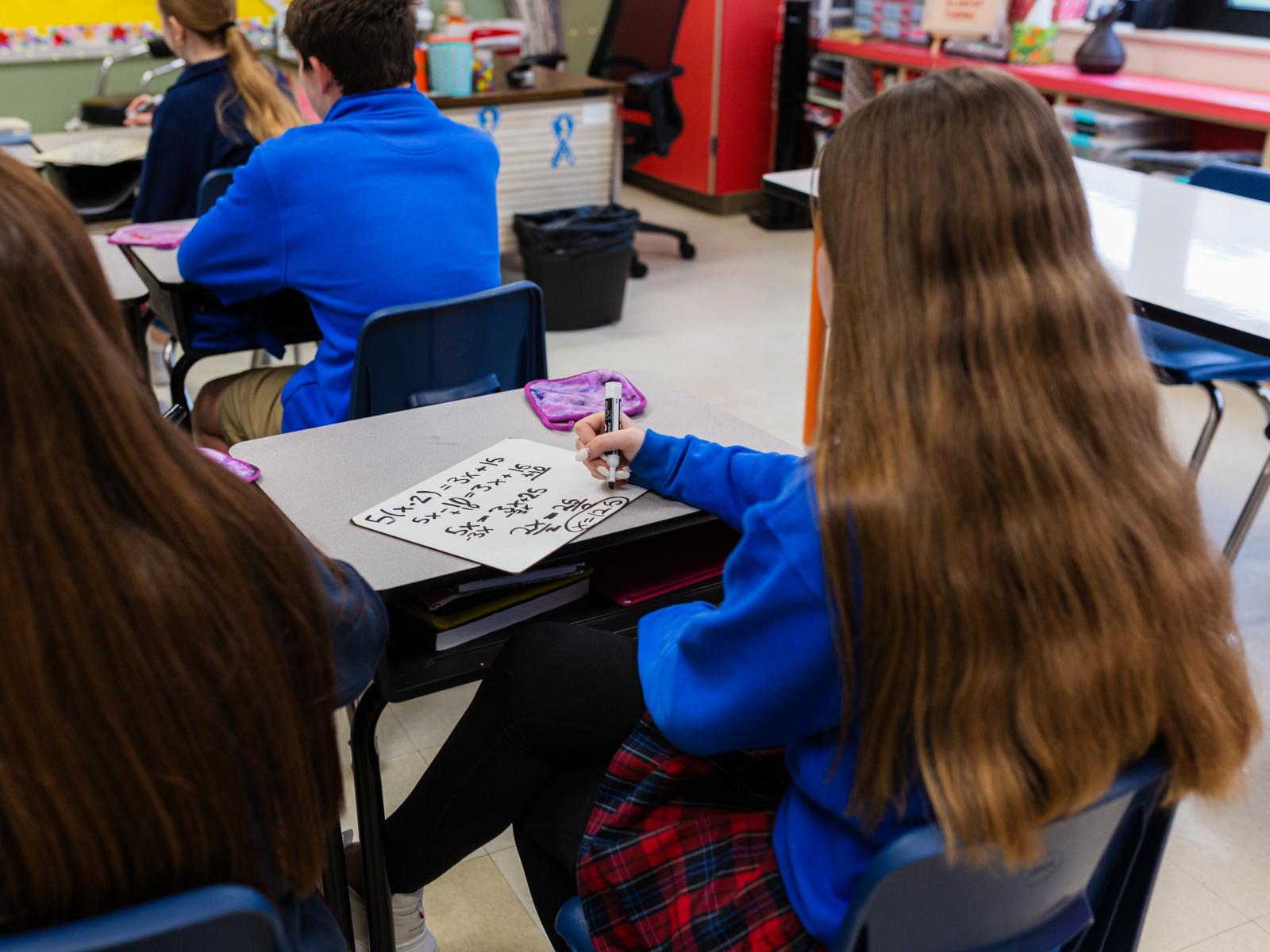 Student taking notes in class