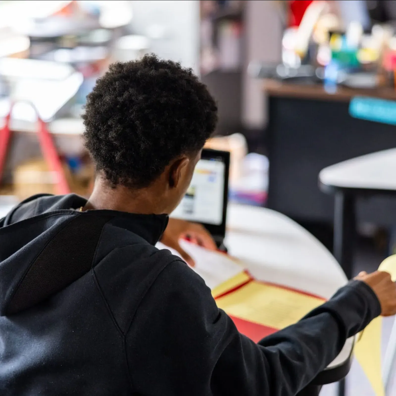 High school student looking at a binder